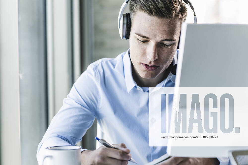 Close-up of male customer representative wearing headset while working in call center model released Symbolfoto property released UUF21479