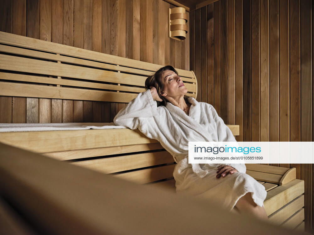 Senior woman with hands behind head relaxing in sauna at health spa model released Symbolfoto property released ZEDF03936