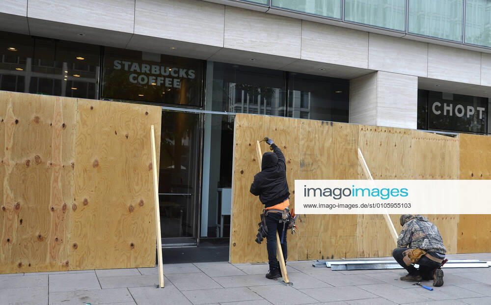Workers board up businesses near the White House, Saturday, October 31, 2020, Washington, DC. Precautions are being made in case of violence on or after Election Day, Tuesday, November 3. WAP20201031501 MIKExTHEILER