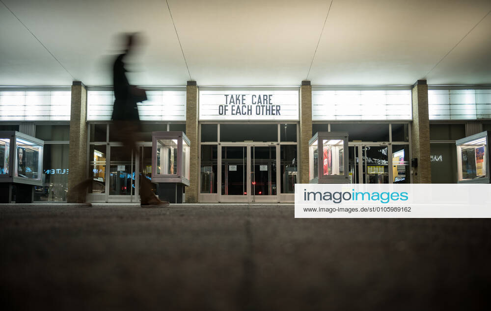 The lettering Take care of each other is on the façade of the Kino International in Berlin Mitte Photo picture enclosure Closed cinema