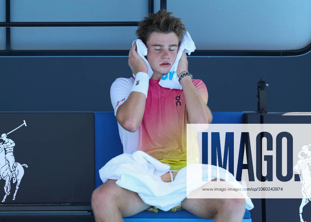 Henry Bernet SUI holds an ice pack to his head because of the heat, , Boys Singles, Australian Open 2025, Melbourne Park, Melbourne, Victoria, Australia