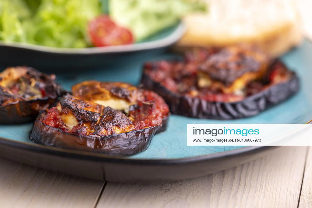 Grilled eggplants with cheese and salad 1035307163