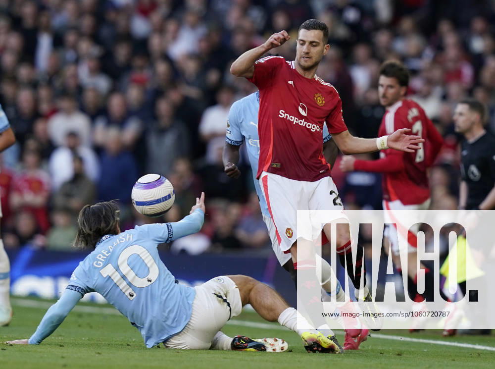 Manchester, England, 6th April 2025. Jack Grealish of Manchester City (L) challenges Diogo Dalot of Manchester United, ManU during the Manchester United vs Manchester City Premier League match at Old Trafford, Manchester. Picture credit should read: Andrew Yates Sportimage . SPI_113_AY_United_City SPI-3814-0114