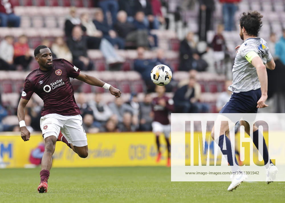 Heart of Midlothian v Dundee William Hill Premiership Joe Shaughnessy of Dundee (right) passes the ball as Elton Kabangu of Heart of Midlothian (left) closes in during the William Hill Premiership match at Tynecastle Park, Edinburgh UK Newspapers OUT