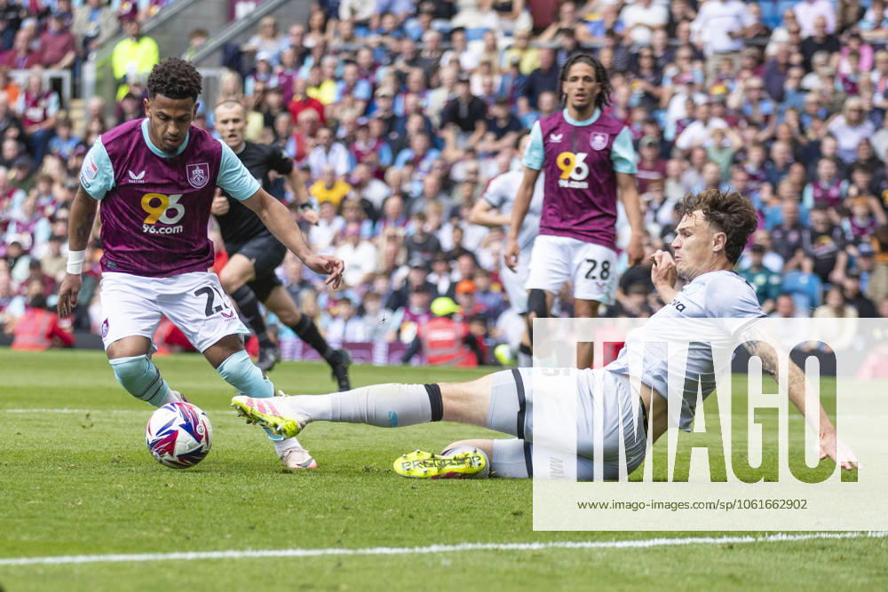 Burnley FC v Millwall FC - Sky Bet Championship Marcus Edwards 22 of Burnley FC is tackled by Jake Cooper 5 of Millwall F.C. during the Sky Bet Championship match between Burnley and Millwall at Turf Moor in Burnley, England, on May 3, 2025. Burnley Lancashire