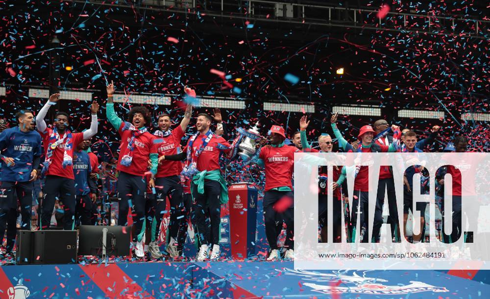 . - Crystal Palace FA Cup Trophy Parade & Celebrations, Selhurst Park Stadium, London, England. - 26th May 2025. (C) Daniel Weir Crystal Pix Joel Ward of Crystal Palace & Marc Guehi of Crystal Palace hold aloft the Emirates FA Cup Trophy in celebration with there team mates on the stage at Selhurst Park under Confetti during the Crystal Palace FA Cup trophy bus parade & party celebrations at Selhurst Park stadium in South London. - Crystal Palace FA Cup Trophy Parade & Celebrations, Selhurst Park Stadium, London, England. - 26th May 2025. (C) Daniel Weir Crystal Pix London Selhurst Park Stadium United Kingdom