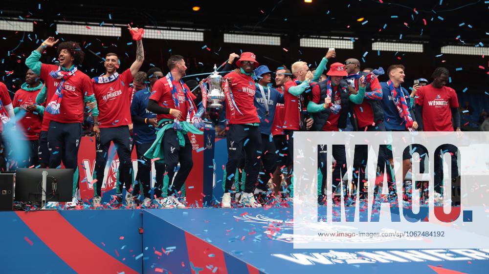 . - Crystal Palace FA Cup Trophy Parade & Celebrations, Selhurst Park Stadium, London, England. - 26th May 2025. (C) Daniel Weir Crystal Pix Joel Ward of Crystal Palace & Marc Guehi of Crystal Palace hold aloft the Emirates FA Cup Trophy in celebration with there team mates on the stage at Selhurst Park under Confetti during the Crystal Palace FA Cup trophy bus parade & party celebrations at Selhurst Park stadium in South London. - Crystal Palace FA Cup Trophy Parade & Celebrations, Selhurst Park Stadium, London, England. - 26th May 2025. (C) Daniel Weir Crystal Pix London Selhurst Park Stadium United Kingdom