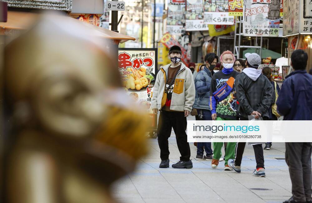Coronavirus surge in Japan People wearing face masks walk in Osaka s Shinsekai area in western Japan on Nov. 12, 2020, amid a surge in coronavirus cases across Japan.