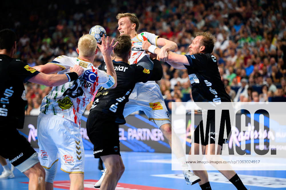 Cologne, Germany Handball EHF CL Final 4 Final Fuechse Berlin SC Magdeburg from left in duel Gisli Thorgeir Kristjansson SC Magdeburg and Max Darj Berlin , Magnus Saugstrup Jensen SC Magdeburg at the circle Cologne Lanxess Arena Nordrhein Westfalen Germany