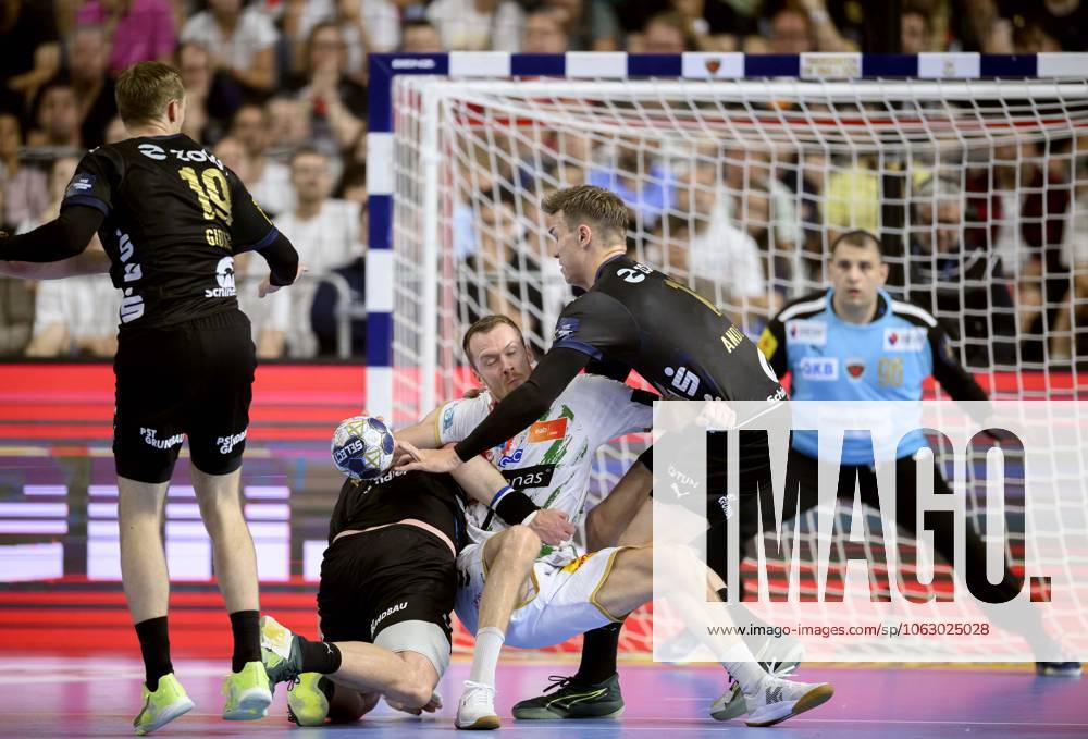 From l Mathias GIDSEL B , Mijajlo MARSENIC B , Felix CLAAR MD , Lasse ANDERSSON B , action, duel, Handball Champions League Final Four 2025, Final, Fuechse Berlin B SC Magdeburg MD , on 15 06 2025 in Cologne Germany Â