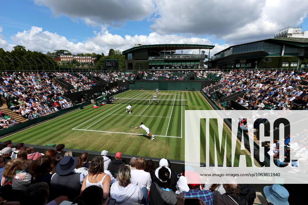 7th July 2025; All England Lawn Tennis and Croquet Club, London, England; Wimbledon Tennis Tournament, Day 8; Guido Andreozzi (ARG) with a backhand shot to Lloyd Glasspool (GBR) on court two during the mens doubles match as dark clouds loom over the All England Lawn Tennis and Croquet Club ActionPlus12811188 JohnxPatrickxFletcher