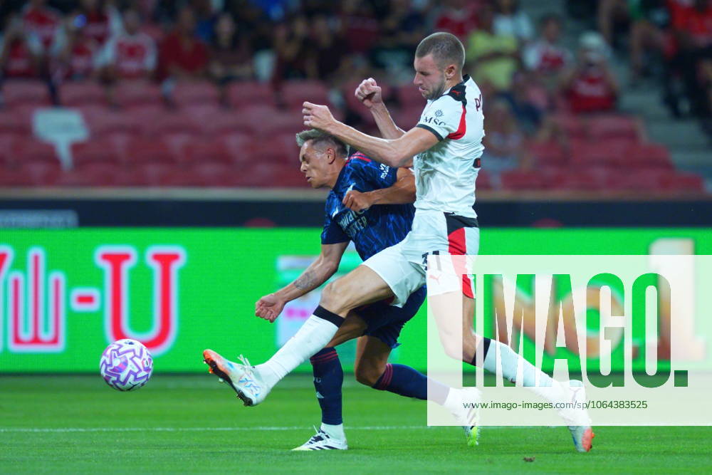 Arsenal FC V AC Milan - Pre-Season Friendly Match Leandro Trossard of Arsenal and Strahinja Pavlovic of AC Milan challenge for the ball during the pre-season friendly match between Arsenal FC and AC Milan at National Stadium in Singapore on July 23, 2025. Singapore Singapore