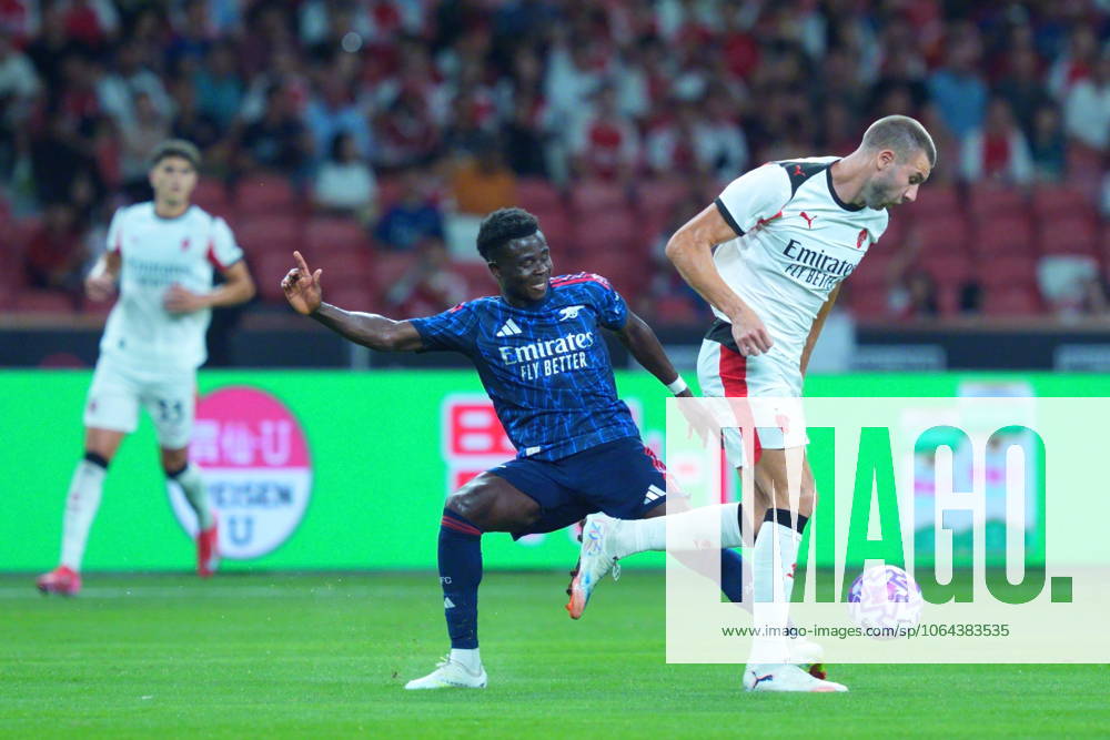 Arsenal FC V AC Milan - Pre-Season Friendly Match Bukayo Saka of Arsenal challenges Strahinja Pavlovic of AC Milan during the pre-season friendly match between Arsenal FC and AC Milan at National Stadium in Singapore on July 23, 2025. Singapore Singapore