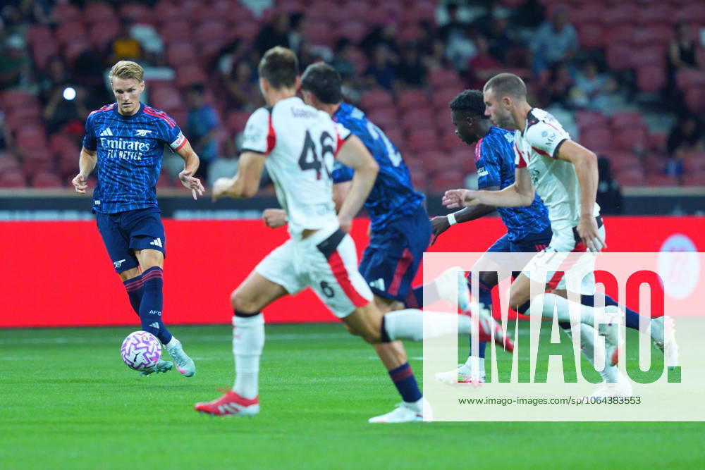 Arsenal FC V AC Milan - Pre-Season Friendly Match Martin Odegaard of Arsenal controls the ball during the pre-season friendly match between Arsenal FC and AC Milan at National Stadium in Singapore on July 23, 2025. Singapore Singapore