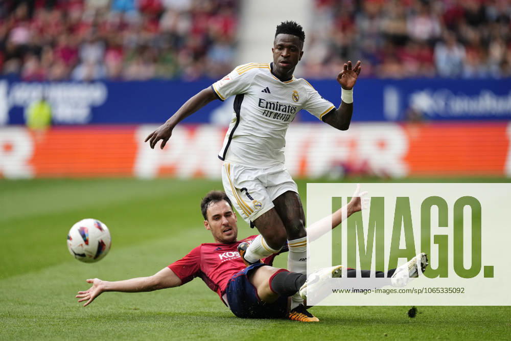 CA Osasuna v Real Madrid CF - LaLiga EA Sports PAMPLONA, SPAIN - MARCH 16: Vinicius Junior (top) left winger of Real Madrid and Brazil and Unai Garcia (ground) centre-back of Osasuna and Spain compete for the ball during the LaLiga EA Sports match between CA Osasuna and Real Madrid CF at Estadio El Sadar on March 16, 2024 in Pamplona, Spain. Spain World. Editorial use only. Please get in touch for any other usage.