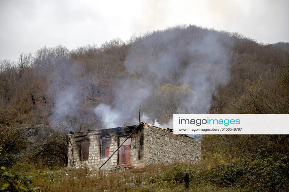 A burning house left by residents in the village of Chorekdar. On 10 November, Armeniaâ€s Prime Minister Nikol Pashinyan, Russiaâ€s President Vladimir Putin, and Azerbaijanâ€s President Ilham Aliyev signed a joint statement on a complete ceasefire in Nagorno-Karabakh. The Russian leader said the Azerbaijani and Armenian sides would maintain the positions that they had held and Russian peacekeepers would be deployed to the region. According to the document, Armenia has to hand over the Nagorno-Karabakh districts of Kalbajar, Lachin, and Agdam, to Azerbaijan till November 15, December 1, and November 20, respectively. Stanislav Krasilnikov TASS TS0EE409