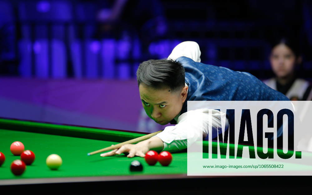 Xiao Guodong of China plays a shot in the first round match against Mink Nutcharut of Thailand on day 1 of the 2025 Wuhan Open Qualifiers at Optics Valley Gymnasium of HUST on August 24, 2025 in Wuhan, Hubei Province of China.