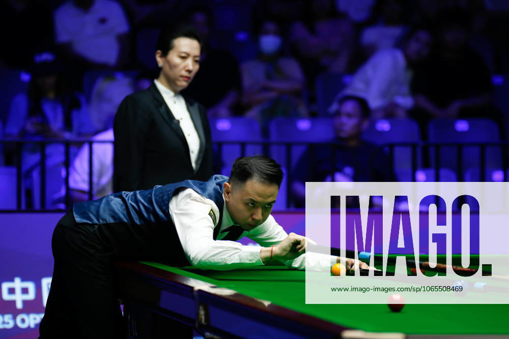 Xiao Guodong of China plays a shot in the first round match against Mink Nutcharut of Thailand on day 1 of the 2025 Wuhan Open Qualifiers at Optics Valley Gymnasium of HUST on August 24, 2025 in Wuhan, Hubei Province of China.