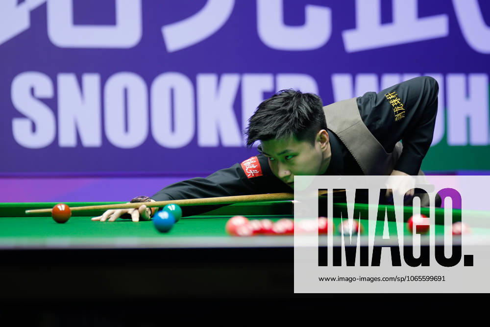 Zhao Xintong of China plays a shot in the third round match against Stephen Maguire of Scotland on day 3 of the 2025 Wuhan Open Qualifiers at Optics Valley Gymnasium of HUST on August 26, 2025 in Wuhan, Hubei Province of China.