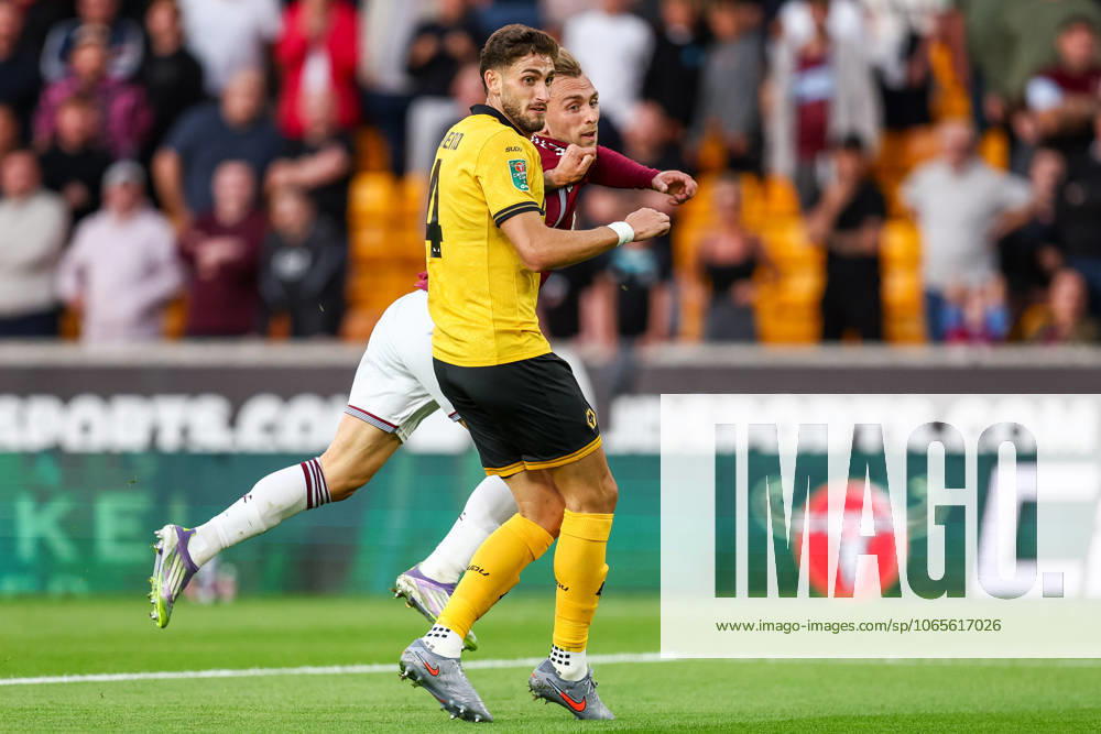 Wolverhampton Wanderers v West Ham United - Carabao Cup Second Round Santiago Bueno of Wolverhampton Wanderers tries to block the shot by Jarrod Bowen of West Ham during the Carabao Cup match between Wolverhampton Wanderers and West Ham United at Molineux in Wolverhampton, on August 26, 2025. Wolverhampton West Midlands United Kingdom