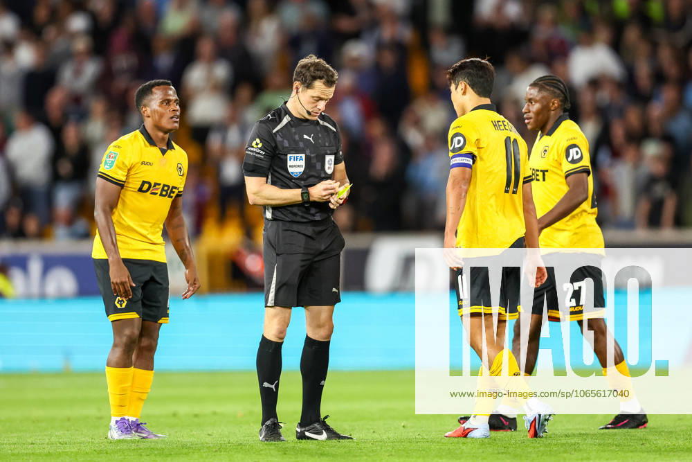 Wolverhampton Wanderers v West Ham United - Carabao Cup Second Round Referee Darren England notes a caution as Wolverhampton Wanderers players surround him during the Carabao Cup match between Wolverhampton Wanderers and West Ham United at Molineux in Wolverhampton, United Kingdom, on August 26, 2025. Wolverhampton West Midlands United Kingdom