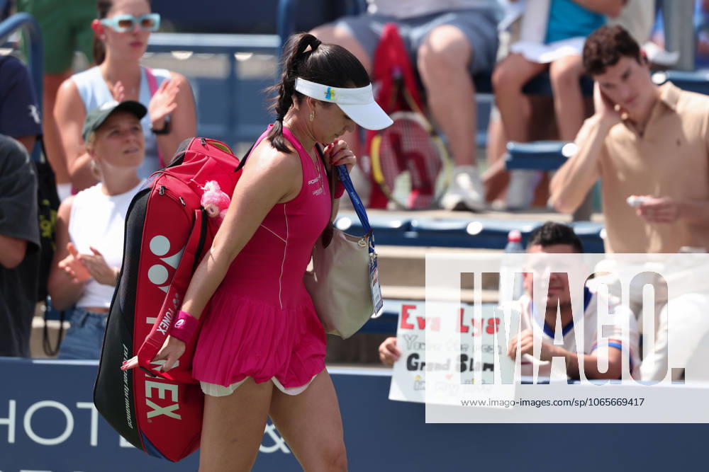 Eva Lys GER leaves the court after her retirement, a fan sits in the background with a poster, USTA Billie Jean King National Tennis Center, Flushing Meadows, New York, USA