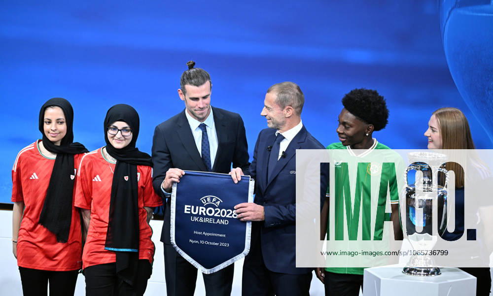 Ireland and United Kingdom confirmed to co-host 2028 UEFA European Football Championship GENEVA, SWITZERLAND - OCTOBER 10: UEFA President Aleksander Ceferin (3rd R) and Welsh retired professional footballer, heading the delegation of UK and Ireland Gareth Bale (3rd L) hold the pennant as they pose with the pennant next to the trophy after United Kingdom and Ireland were elected to host the Euro 2028 football tournament during a ceremony held after the Executive Board meeting at the UEFA headquarters in Nyon, Geneva, Switzerland on October 10, 2023. Geneve Isviçre. Editorial use only. Please get in touch for any other usage.