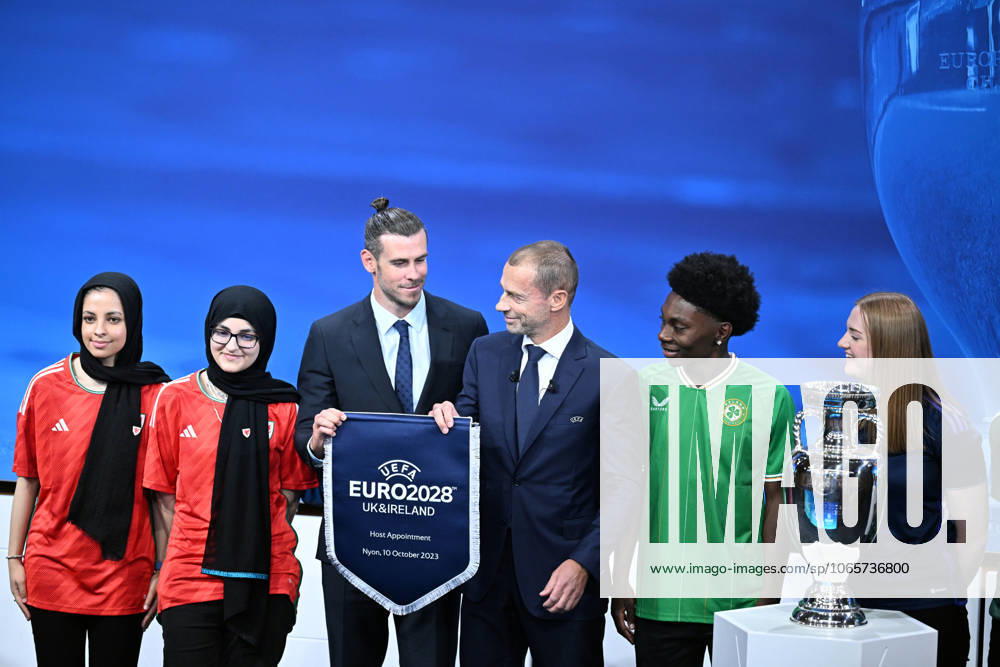 Ireland and United Kingdom confirmed to co-host 2028 UEFA European Football Championship GENEVA, SWITZERLAND - OCTOBER 10: UEFA President Aleksander Ceferin (3rd R) and Welsh retired professional footballer, heading the delegation of UK and Ireland Gareth Bale (3rd L) hold the pennant as they pose with the pennant next to the trophy after United Kingdom and Ireland were elected to host the Euro 2028 football tournament during a ceremony held after the Executive Board meeting at the UEFA headquarters in Nyon, Geneva, Switzerland on October 10, 2023. Geneve Isviçre. Editorial use only. Please get in touch for any other usage.