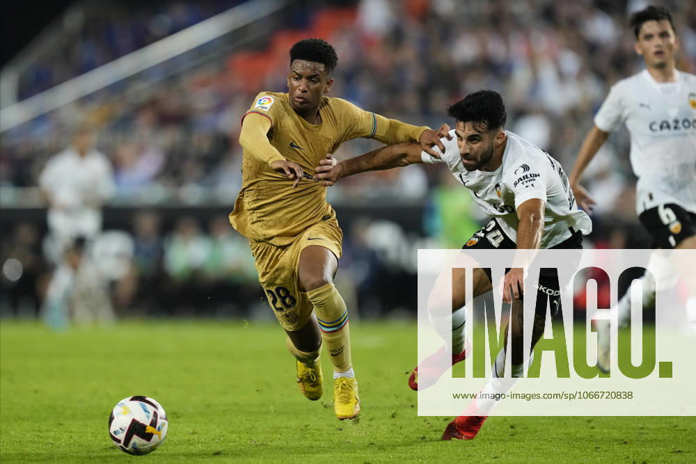 Valencia CF v FC Barcelona, Barca - LaLiga Santander VALENCIA, SPAIN - 29 October: Alejandro Balde left-back of Barcelona and Spain and Eray Comert Centre-Back of Valencia and Switzerland compete for the ball during the La Liga Santander match between Valencia CF and FC Barcelona at Estadio Mestalla on October 29, 2022 in Valencia, Spain. Spain World. Editorial use only. Please get in touch for any other usage.