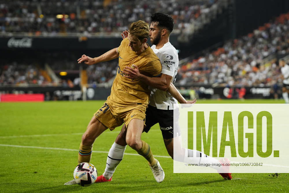 Valencia CF v FC Barcelona, Barca - LaLiga Santander VALENCIA, SPAIN - 29 October: Frenkie de Jong central midfield of Barcelona and Netherlands and Eray Comert Centre-Back of Valencia and Switzerland compete for the ball during the La Liga Santander match between Valencia CF and FC Barcelona at Estadio Mestalla on October 29, 2022 in Valencia, Spain. Spain World. Editorial use only. Please get in touch for any other usage.