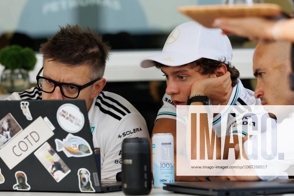 Andrea Kimi Antonelli of Italy and the Mercedes-AMG PETRONAS Formula One Team (C) seen with team engineer Peter Bonnington (L) in the paddock ahead of the F1 Grand Prix of Singapore at the Marina Bay Street Circuit. Singapore Singapore - ZUMAs197 20251002_aaa_s197_177