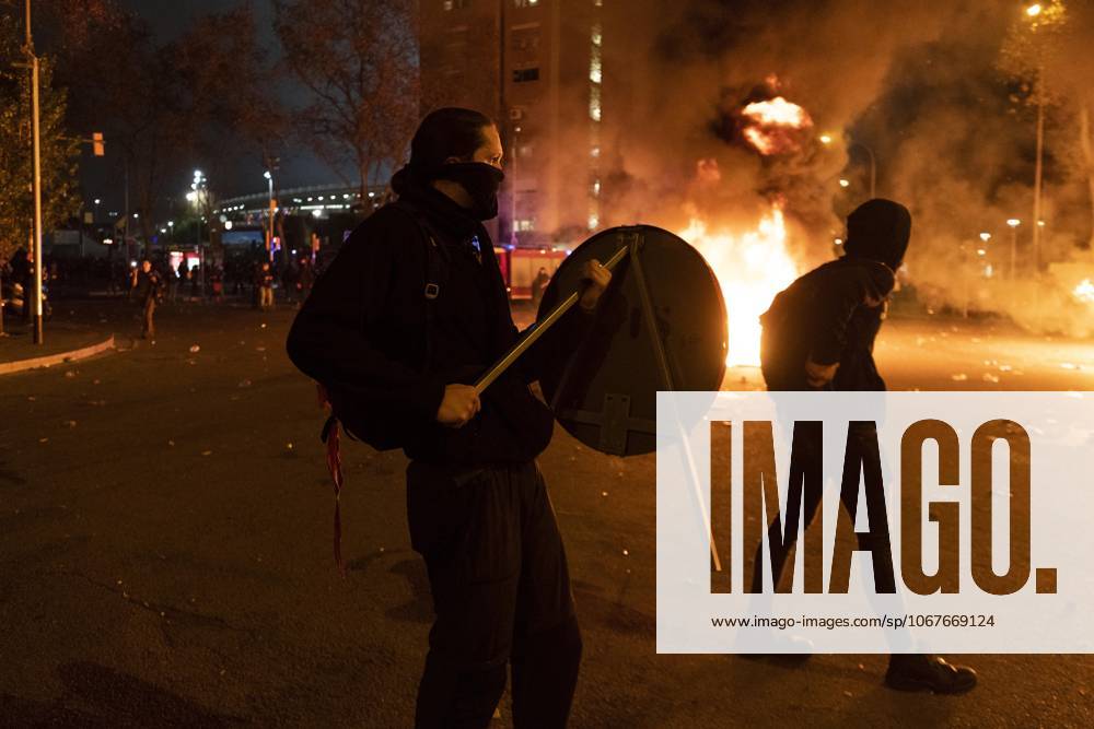 FC Barcelona, Barca v Real Madrid: La Liga BARCELONA, SPAIN - DECEMBER 18: A protester carries a traffic sign near a burning barricade during a protest called by Catalan separatist movement Democratic Tsunami outside the Camp Nou stadium in Barcelona on December 18, 2019, during the El Clasico Spanish League football match between Barcelona FC and Real Madrid CF. Catalonia Spain. Editorial use only. Please get in touch for any other usage.