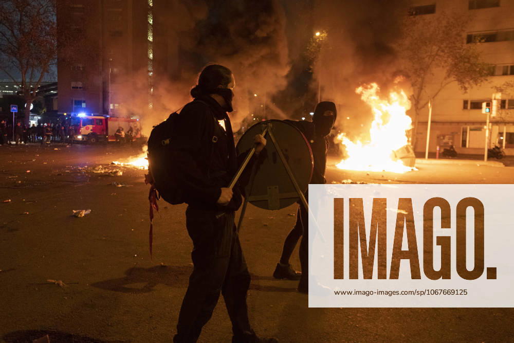 FC Barcelona, Barca v Real Madrid: La Liga BARCELONA, SPAIN - DECEMBER 18: A protester carries a traffic sign near a burning barricade during a protest called by Catalan separatist movement Democratic Tsunami outside the Camp Nou stadium in Barcelona on December 18, 2019, during the El Clasico Spanish League football match between Barcelona FC and Real Madrid CF. Catalonia Spain. Editorial use only. Please get in touch for any other usage.