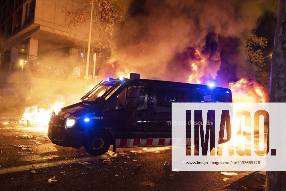 FC Barcelona, Barca v Real Madrid: La Liga BARCELONA, SPAIN - DECEMBER 18: A van of Catalan regional police Mossos D Esquadra officers drives by carbage containers burning during a demonstration called by Catalan separatist movement Democratic Tsunami outside the Camp Nou stadium in Barcelona on December 18, 2019, after the El Clasico Spanish League football match between Barcelona FC and Real Madrid CF Catalonia Spain. Editorial use only. Please get in touch for any other usage.