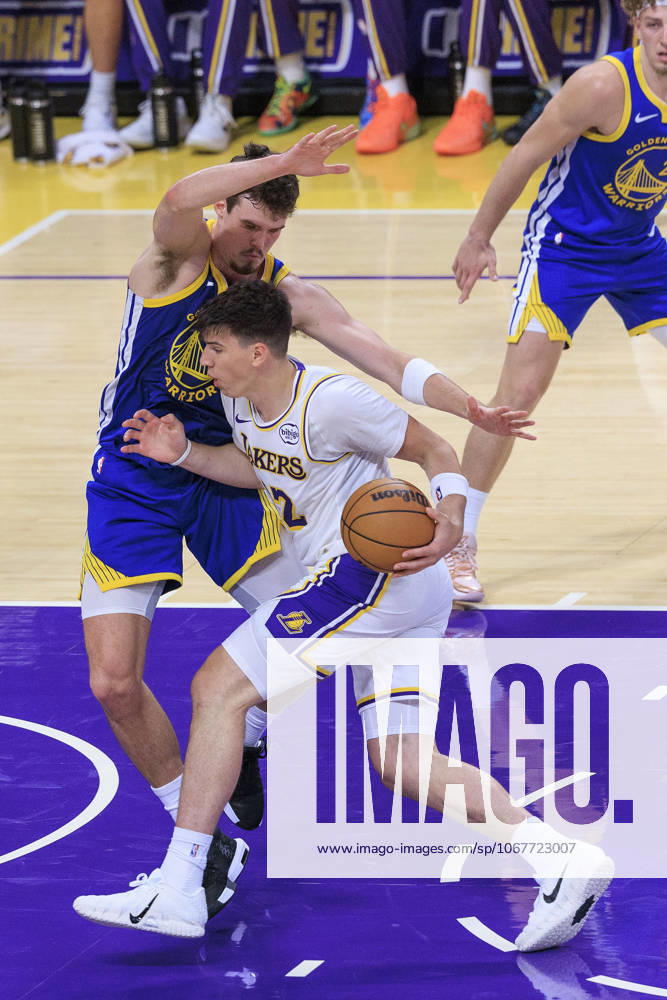 Jake LaRavia 12 of the Los Angeles Lakers is blocked by Quinten Post 21 of the Golden State Warriors as he goes for a basket during their preseason NBA, Basketball Herren, USA game on Sunday October 12, 2025 at Crypto.com Arena in Los Angeles, California. Lakers defeat Warriors, 126-116. JAVIER ROJAS PI Los Angeles USA - ZUMAp124 20251012_zaa_p124_147