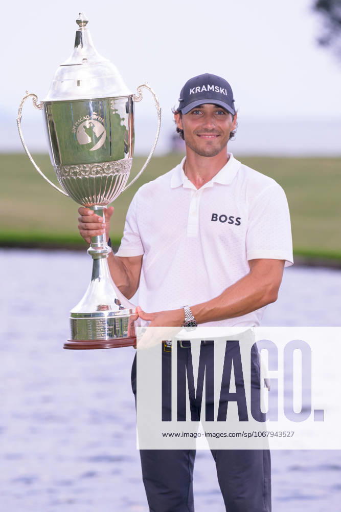 Macau Open Golf , Final Round, Macau Golf and Country Club Coloane, Macao, China . GermanyÃ¢â‚¬â ¢s Dominic Foos Wins the Macau Open Golf after a tiebreaker with Taiwans Wang, Wei-hsuan. Foos holds the cup by the lake on the 18th fairway. Macao China - ZUMAr144 20251019_zap_r144_009