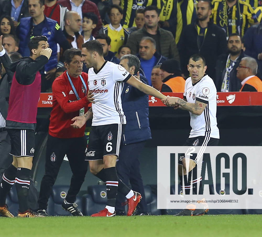 Fenerbahce v Besiktas: Ziraat Turkish Cup ISTANBUL, TURKEY - APRIL 19: Medel (R) of Besiktas tries to calm his teammate Dusko Tosic (C) down during Ziraat Turkish Cup Semi Final second leg soccer match between Fenerbahce and Besiktas at the Ulker Stadium in Istanbul, Turkey on April 19, 2018. The match was cancelled after the latest incidents. Istanbul Turkey. Editorial use only. Please get in touch for any other usage.