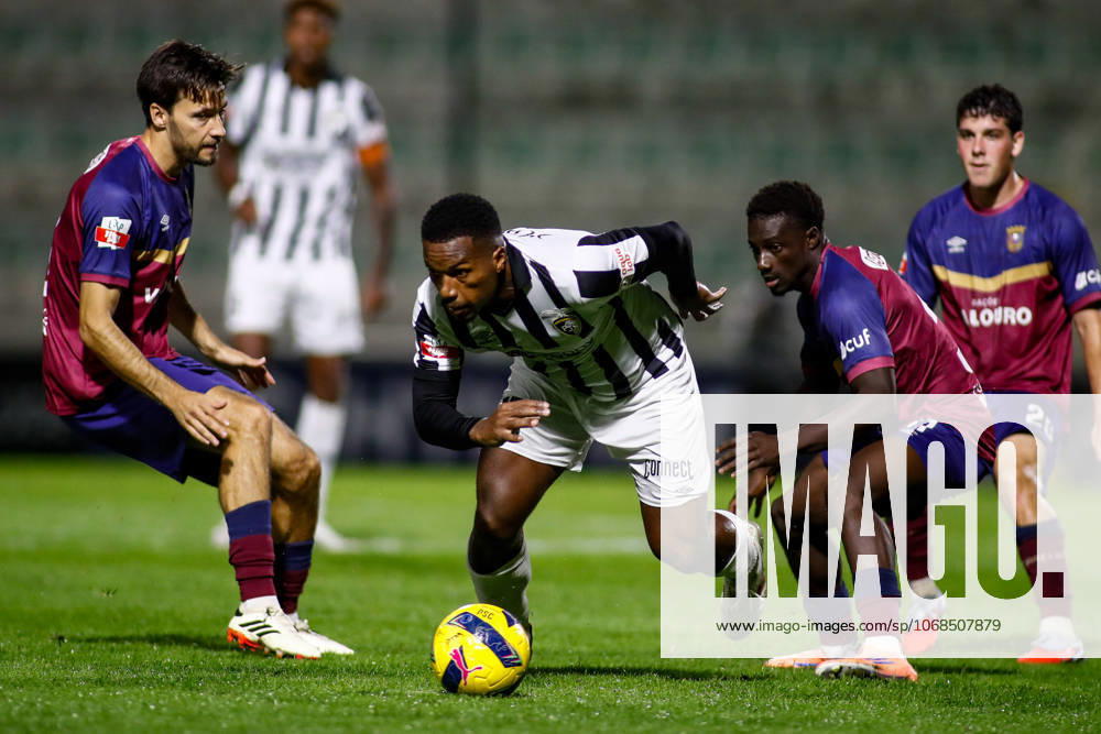 Liga Portugal 2: Portimonense - Torreense Portimao, Portugal - 30 10 2025: Liga Portugal 2 Meu Super 9th round match between SC Portimonense and SCU Torreense at Estadio Municipal de Portimao 15 Portimonense midfielder, Joao Vitor Xavier de Almeida running forward with the ball between Torreense players Mandatory Credit: Toby Tande Avant Sports Agency Portimao Estadio Municipal de Portimao Portugal