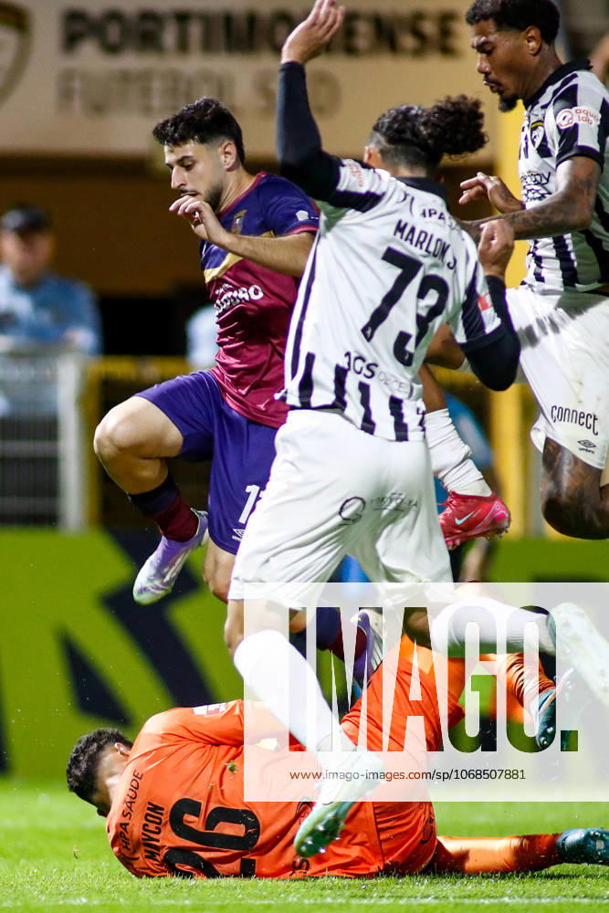 Liga Portugal 2: Portimonense - Torreense Portimao, Portugal - 30 10 2025: Liga Portugal 2 Meu Super 9th round match between SC Portimonense and SCU Torreense at Estadio Municipal de Portimao 26 Portimonense goalkeeper, Maycon Cleiton slides out to save the ball ahead of 11 Torreense attacker, Manu Pozo chased by 73 Portimonense defender, Marlon Galvao Oliveira Junior Mandatory Credit: Toby Tande Avant Sports Agency Portimao Estadio Municipal de Portimao Portugal