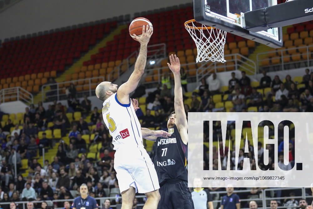 FIBA World Cup Qualifiers : Cyprus vs Germany SIMON MICHAIL of Cyprus scores in front of JOSHUA OBIESIE of Germany. Cyprus plays vs Germany for the Group E of the FIBA Basketball World Cup European Qualifiers, at Spyros Kyprianou Arena, Limassol, Cyprus, on Dec. 1, 2025. Limassol Cyprus
