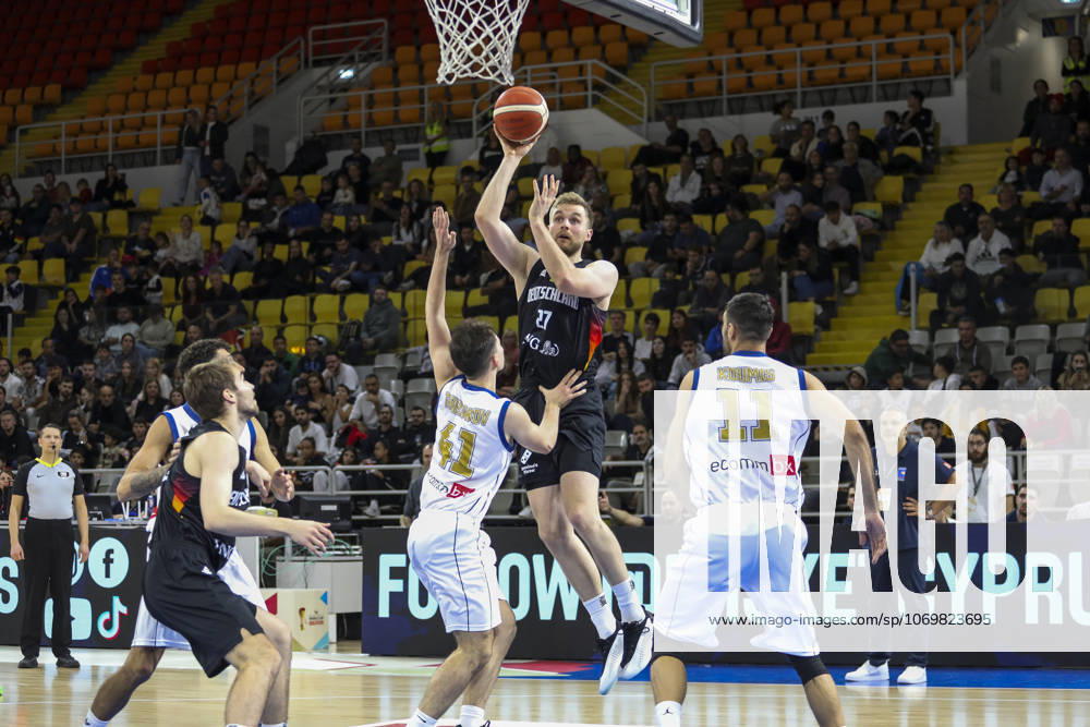 FIBA World Cup Qualifiers : Cyprus vs Germany TILL PAPE of Germany scores in front of GEORGIOS TRETIAKOV of Cyprus abd MICHALIS KOUMIS of Cyprus. Cyprus plays vs Germany for the Group E of the FIBA Basketball World Cup European Qualifiers, at Spyros Kyprianou Arena, Limassol, Cyprus, on Dec. 1, 2025. Limassol Cyprus