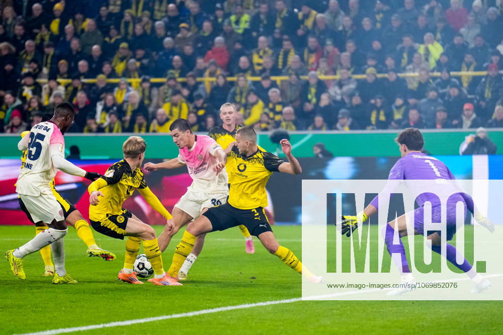Ibrahim Maza of Bayer 04 Leverkusen shoots to score his team s first goal past Borussia Dortmund goalkeeper Gregor Kobel during the DFB Cup round of 16 match between Borussia Dortmund and Bayer 04 Leverkusen at Signal Iduna Park on December 2, 2025 in Dortmund, Germany. (Photo by Rene Nijhuis) SPO
