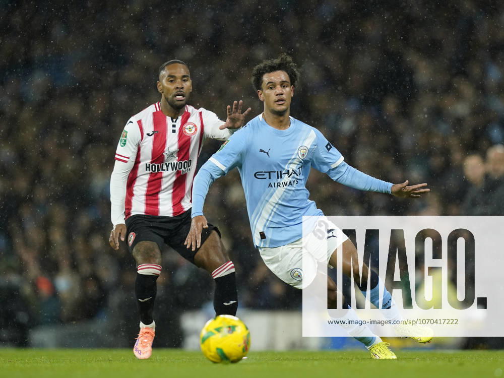 Manchester, England, 17th December 2025. Rico Henry of Brentford (l) shadows Oscar Bobb of Manchester City (r) during the Manchester City vs Brentford Carabao Cup quarter final match at the Etihad Stadium, Manchester. Picture credit should read: Andrew Yates Sportimage . SPI_027_AY_Man_City_Brentford SPI-4382-0027