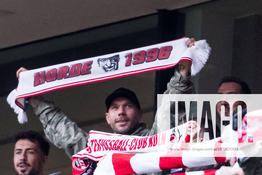 Lukas Podolski (former 1. FC Koeln player) holding up a scarf during the anthem before the Bundesliga match between 1. FC Koeln vs. 1. FC Union Berlin at Rheinenergie-Stadion on matchday 15 of the 1. Bundesliga on December 20, 2025 in Koeln, Germany. DFL REGULATIONS PROHIBIT ANY USE OF PHOTOGRAPHS AS IMAGE SEQUENCES AND OR QUASI-VIDEO. North Rhine Westphalia Germany