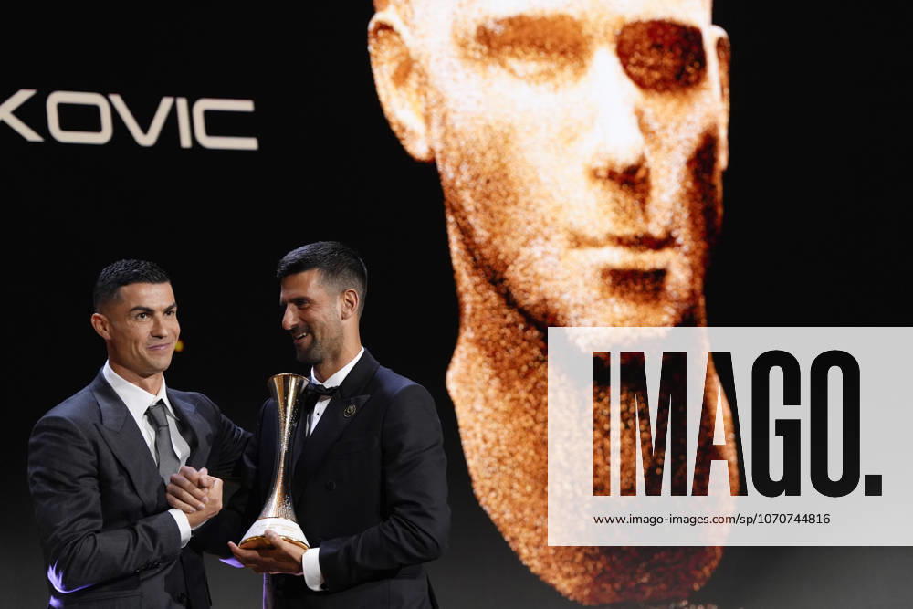 Novak Djokovic receives a prize from Cristiano Ronaldo during the Globe Soccer Awards 2025- 16h edition. in Dubai, UAE - Soccer
