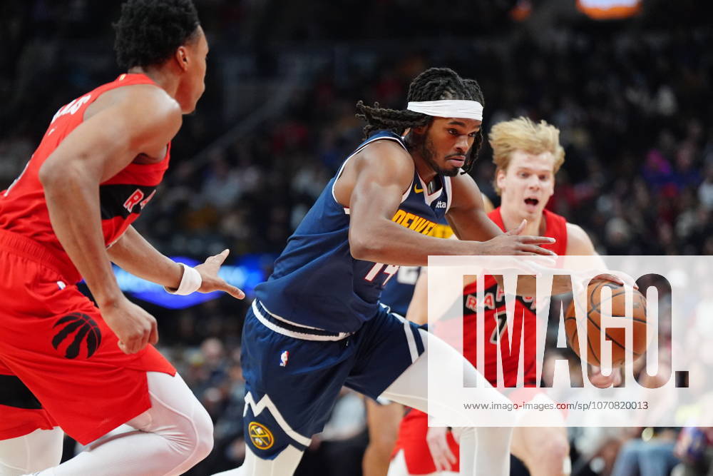 Denver Nuggets forward Daron Holmes II (14) drives up court between Toronto Raptors Scottie Barnes (4) and Raptors guard Gradey Dick (1) during first half NBA, Basketball Herren, USA action in Toronto on Wednesday December 31, 2025. Canada News - December 31, 2025 - ZUMAc35_ 20251231_zaf_c35_051