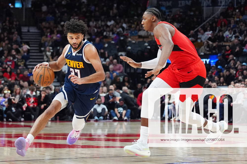 Denver Nuggets guard Jamal Murray (27) moves around Toronto Raptors forward guard RJ Barrett, right, during first half NBA, Basketball Herren, USA action in Toronto on Wednesday December 31, 2025. Canada News - December 31, 2025 - ZUMAc35_ 20251231_zaf_c35_054