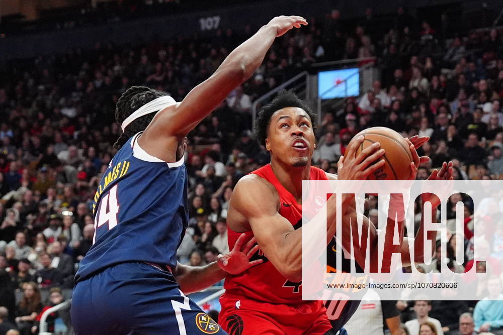 Toronto Raptors forward guard Scottie Barnes (4) heads toward the basket as Denver Nuggets forward Daron Holmes II (14) defends during second half NBA, Basketball Herren, USA action in Toronto on Wednesday December 31, 2025. Canada News - December 31, 2025 - ZUMAc35_ 20251231_zaf_c35_060