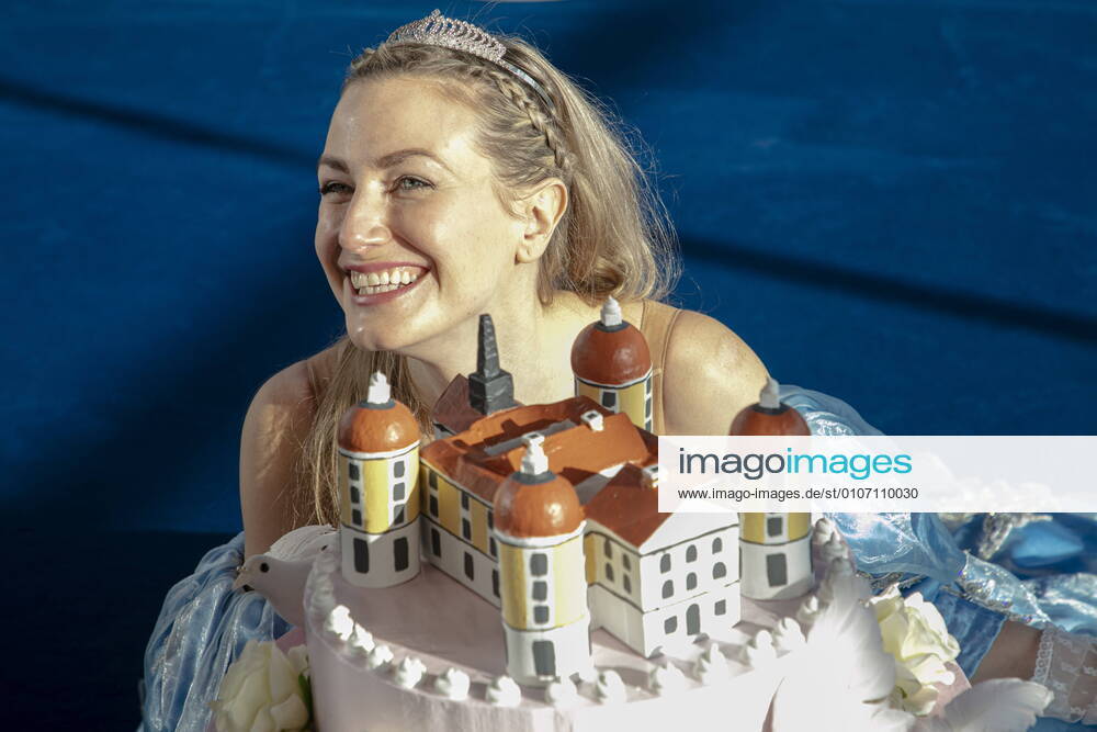 Cinderella the actress Sandra Maria Huimann poses with the new wedding cake which represents the baroque castle Moritzburg In front of the baroque castle scenery in Moritzburg performances of the successful musical Three Hazelnuts for Cinderella are to take place again from July 2021