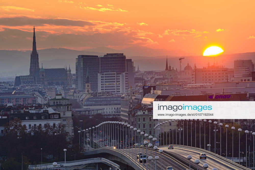 Vienna city center, river Donau (Danube), bridge Reichsbrücke, cathedral Stephansdom, sunset Wien, Vienna Wien Austria 00. overview